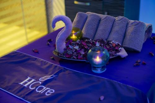 a table with a purple table cloth with a swan and flowers at Radisson Blu Resort Jizan in Jazan