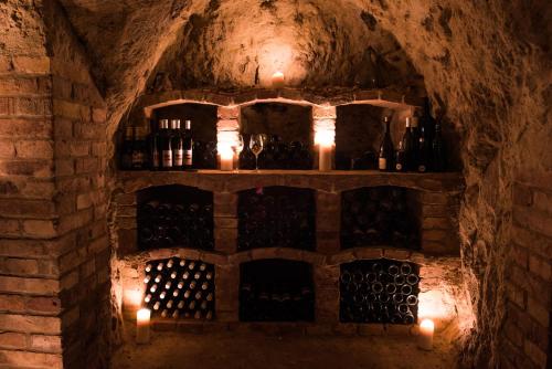 a wine cellar with wine bottles and candles at Levandulová chalupa in Vrbice
