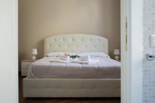 Un pat sau paturi într-o cameră la Marbel - Casa vacanze