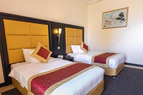 a hotel room with two beds in it at Royal Beach Hotel & Resort in Dibba