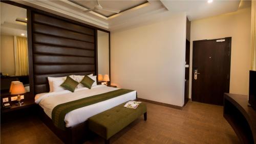 - une chambre avec un grand lit et une télévision dans l'établissement The Livin, à Jaipur