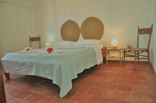 a bedroom with a bed with a table and chairs at Apartments Scopello Inside in Scopello
