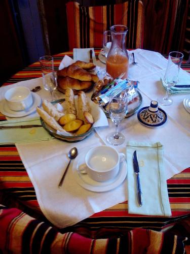 a table with a plate of food on a table at Marie-Claire la grillade in Briare