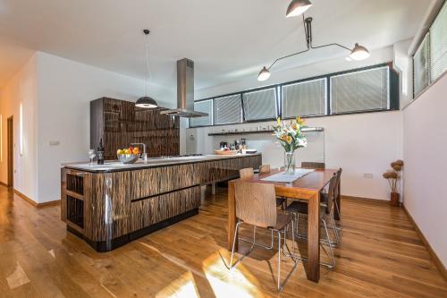 a kitchen with a wooden counter and a wooden table at Villa Breg in Labin