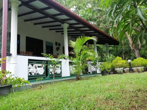 a porch of a house with plants on it at Sigiri Saman Home Stay in Sigiriya