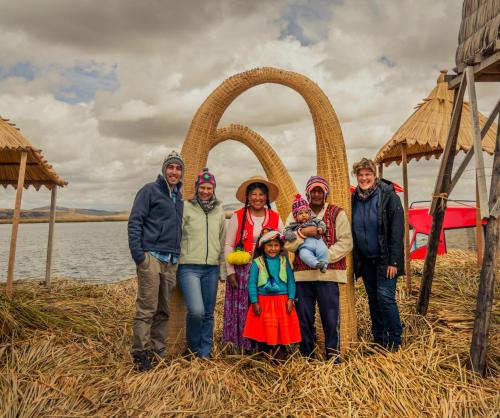 a group of people standing in front of an arch at Uros Samaraña Uta Lodge in Puno
