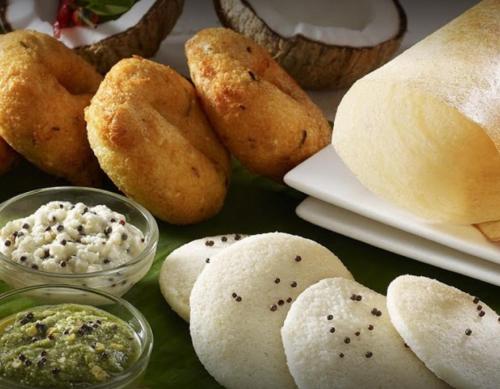 a group of breads with dip on a table at Prime Palace Hotel - MG Road in Cochin