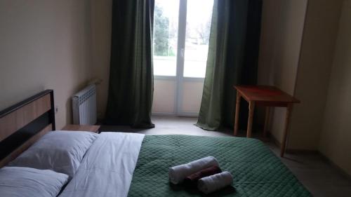 a bedroom with a bed with two towels on it at Central Studio in Ternopilʼ