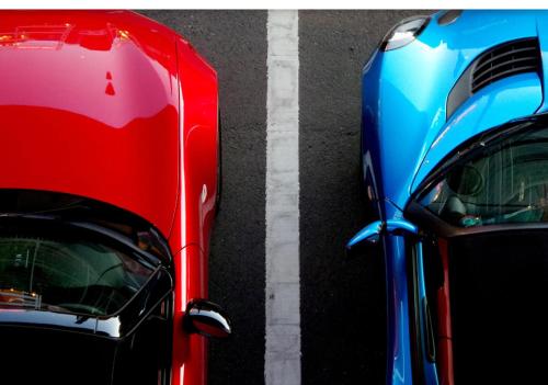 two cars parked next to each other on a street at Best Place Apartments Vienna in Vienna