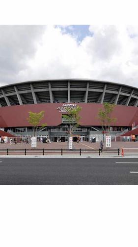 a large stadium with a building in front of it at west crab base in Hiroshima