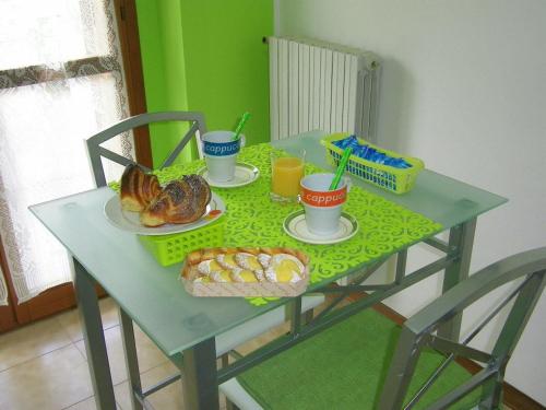 a table with food and drinks and bread on it at B&B La Villetta in San Benedetto del Tronto
