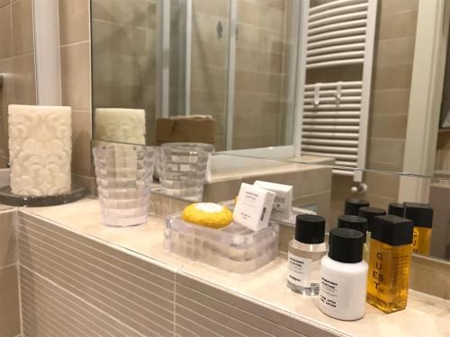 een badkamerbar met cosmetica en een spiegel bij Little Patio in Florence