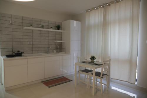 a kitchen with a table and two chairs and a window at Ramallah Modern Apartment in Ramallah