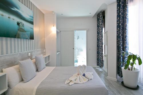 a bedroom with a bed with two towels on it at Hostal Main Street Madrid in Madrid