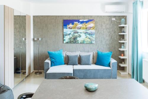 a living room with a couch and blue pillows at Luxury Flat 9 near Metro in Bucharest