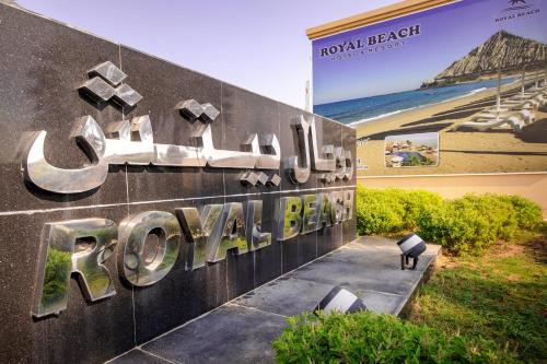 a sign for a hotel in front of a building at Royal Beach Hotel & Resort in Dibba