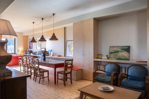 a kitchen and living room with a table and chairs at Borgo Argiano in Castelnuovo Berardenga