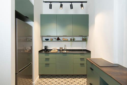 a kitchen with a sink, stove, and cabinets at Oliver in Tel Aviv
