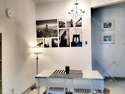 a dining room with a white table and chairs at Home Sweet Home 2 in Semenyih
