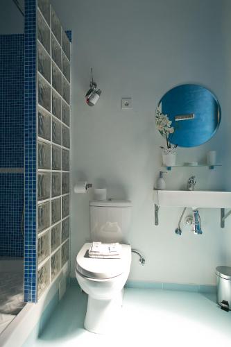 a bathroom with a white toilet and a blue wall at Hostal Main Street Madrid in Madrid
