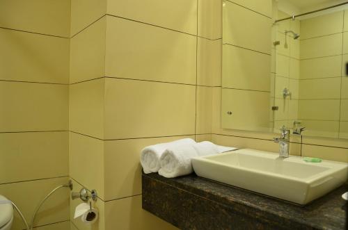 a bathroom with a sink and a mirror at Best Western Swing High Katra in Katra
