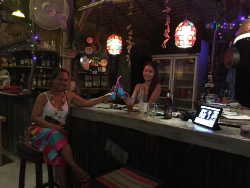 a man and a woman sitting at a bar at Freedom home in Ko Chang
