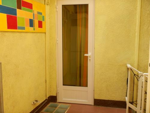 a white door in a room with a painting at Sweet Beach Bungalow in Tamarin