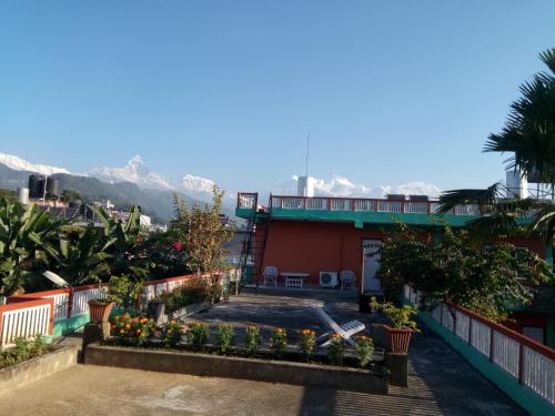 a view of a house with mountains in the background at New Pokhara Lodge - Pokhara Lakeside in Pokhara