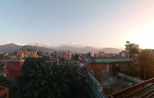 a view of a city with mountains in the background at New Pokhara Lodge - Pokhara Lakeside in Pokhara