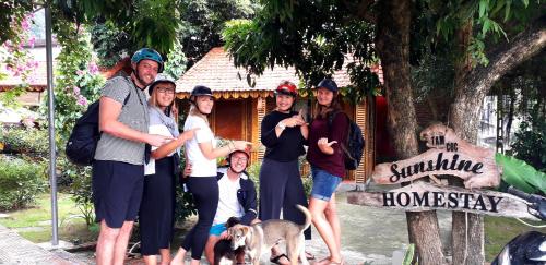 a group of people standing in front of a house at Tam Coc Sunshine Homestay in Ninh Binh