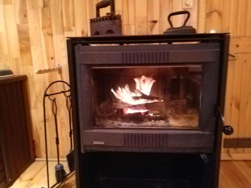 a fireplace in a room with a fire in it at Charmes de Velupont with Wellness in Braives