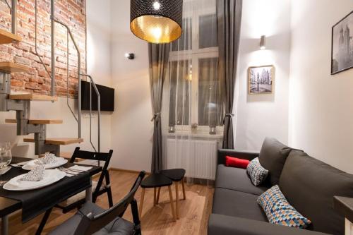 a living room with a couch and a table at DIETLA 99 APARTMENTS - IDEAL LOCATION - in the heart of Krakow in Kraków