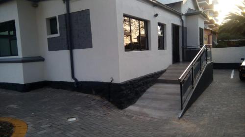 a building with a staircase next to a house at E-JOFF Lodge in Johannesburg