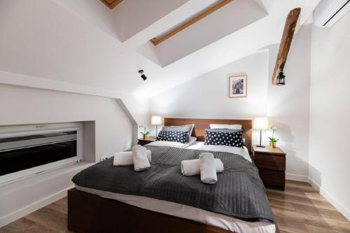 a bedroom with a large bed and a fireplace at DIETLA 99 APARTMENTS - IDEAL LOCATION - in the heart of Krakow in Kraków