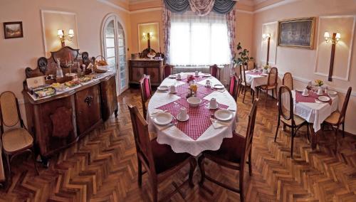 a dining room with a table and chairs in it at Kikelet Panzio in Dunakeszi