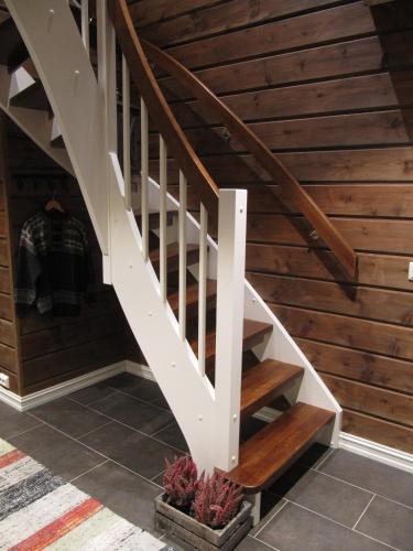 a staircase in a house with wooden walls at Malangen Lodge in Mestervik
