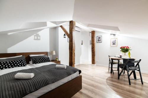 a bedroom with a large bed and a table at DIETLA 99 APARTMENTS - IDEAL LOCATION - in the heart of Krakow in Kraków