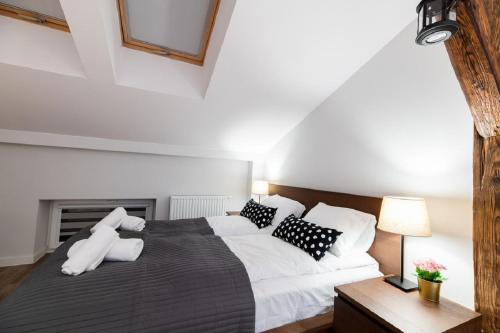 a bedroom with a large bed with white sheets and pillows at DIETLA 99 APARTMENTS - IDEAL LOCATION - in the heart of Krakow in Kraków
