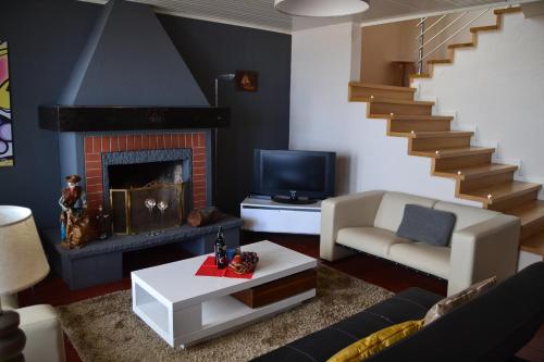 a living room with a fireplace and a staircase at Holiday House 4 You in Funchal