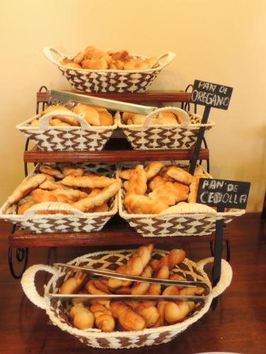 a group of baskets of bread on a table at Hotel Mitru in Tupiza