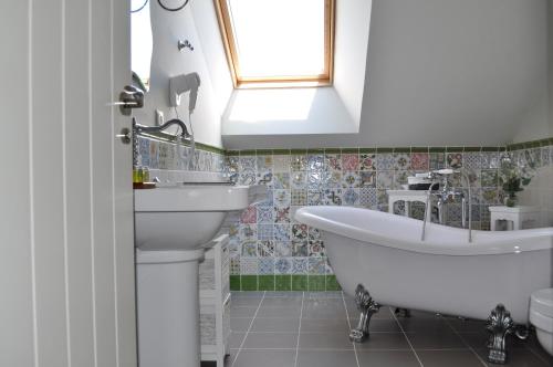 biała łazienka z wanną i umywalką w obiekcie Enoturismo Lagar De Costa w mieście Castrelo