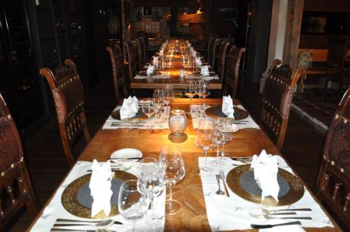 a long table with wine glasses and napkins on it at Stammhaus im Hotel Alpine Palace in Saalbach Hinterglemm