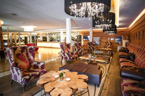 a lobby with couches and tables in a store at Stammhaus im Hotel Alpine Palace in Saalbach Hinterglemm