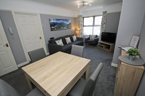 a living room with a table and a couch at Modern Belfast Apartment in Belfast