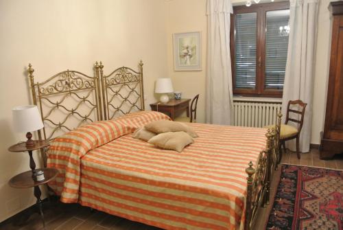 a bedroom with a bed with two pillows on it at VILLA LE ROSE in Cavour