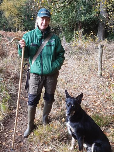 a man is standing next to a dog at B&B de Panheide in Hooghalen