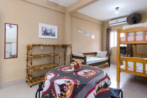 a room with a bed and a table in a room at Recanto Maranduba in Ubatuba