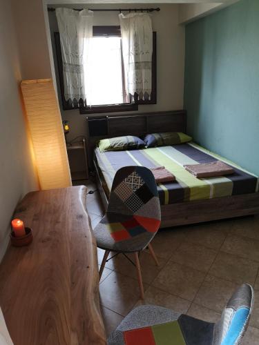 a bedroom with a bed and a table and a chair at Studios Arabas in Thessaloniki