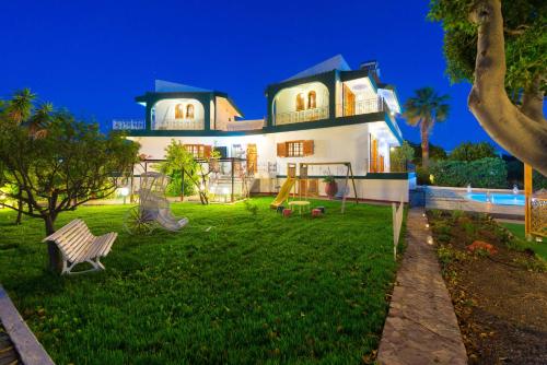 a house with a playground in the yard at Villas Marianna in Kalavárda
