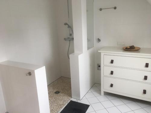 a white bathroom with a dresser and a sink at Ferienglück Lindwedel in Lindwedel